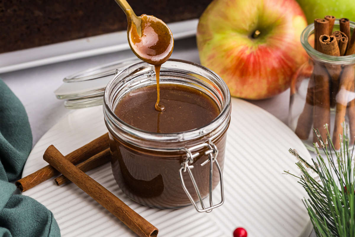 spoon dipping into jar of gingerbread caramel sauce