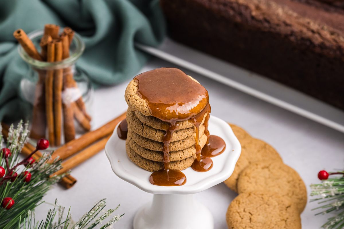 angled shot of stack of gingersnaps with caramel dripping down sides