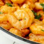 close up angled shot of marinated shrimp in pan