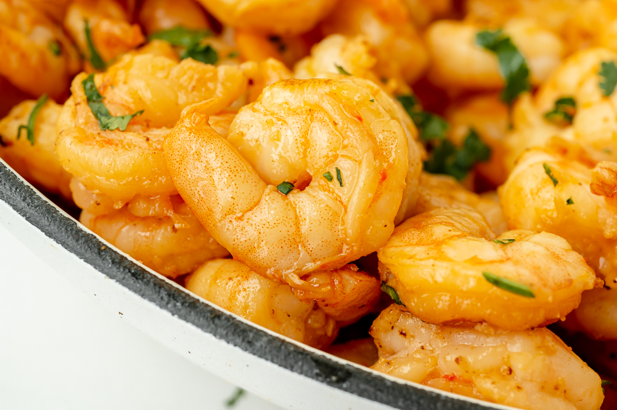 close up angled shot of marinated shrimp in pan