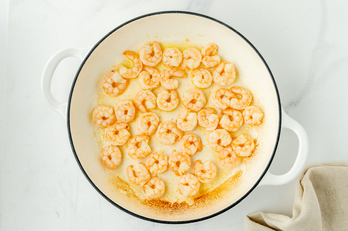 overhead shot of shrimp cooking in pan