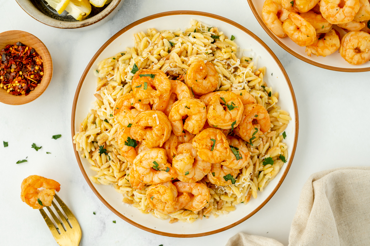 overhead shot of marinated shrimp over orzo