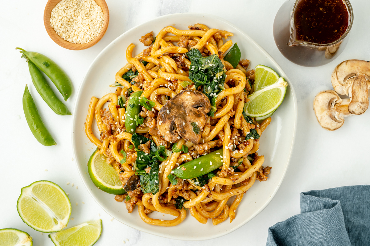 overhead shot of plate of udon noodles and vegetables