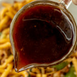 close up of udon noodle sauce pouring out of jar