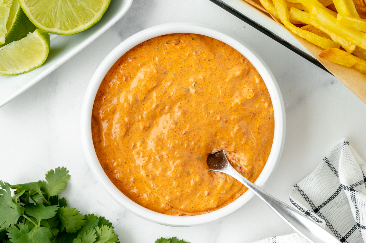 overhead shot of spoon in bowl of chipotle mayo