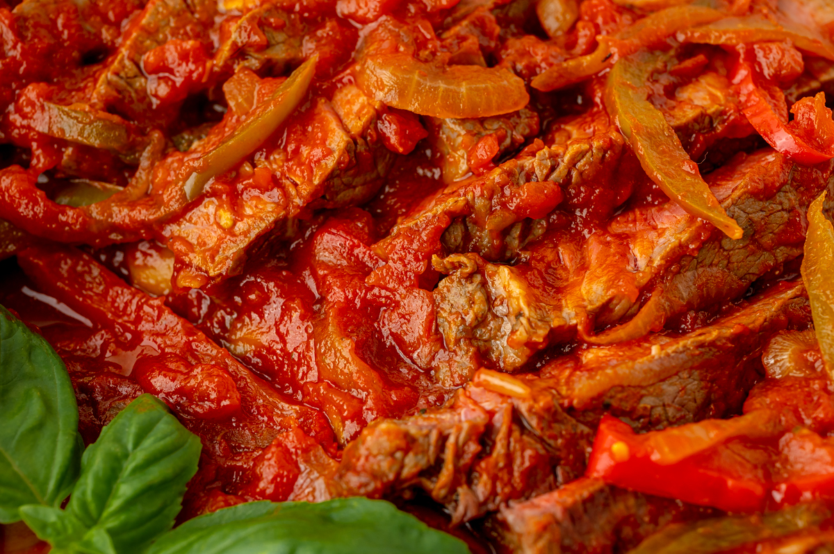 close up of steak in pizzaiola sauce