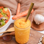 spoon in jar of orange sauce