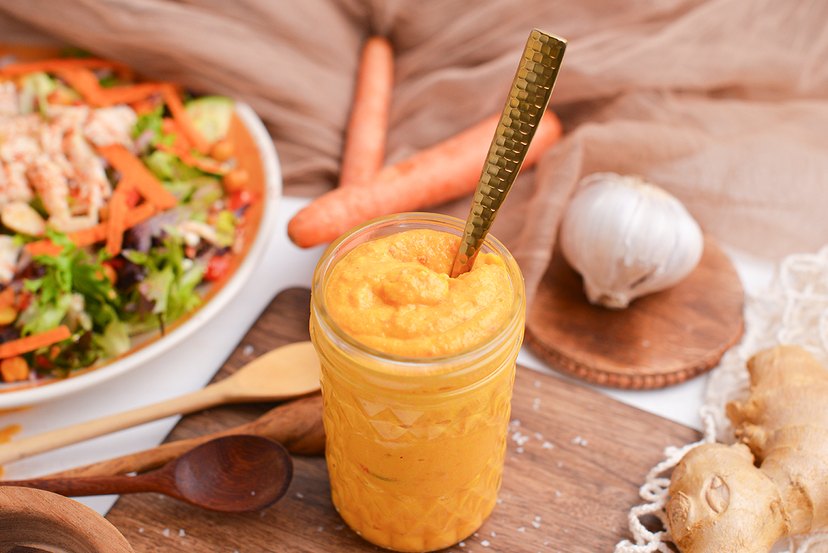 spoon in jar of orange sauce