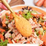 spoon adding dressing to salad with text overlay