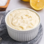 angled shot of bowl of homemade aioli sauce