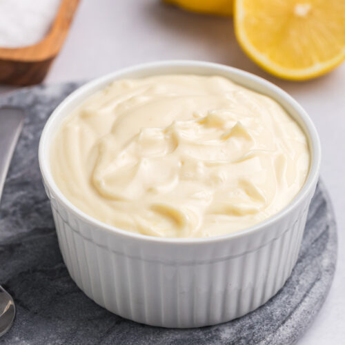 angled shot of bowl of homemade aioli sauce