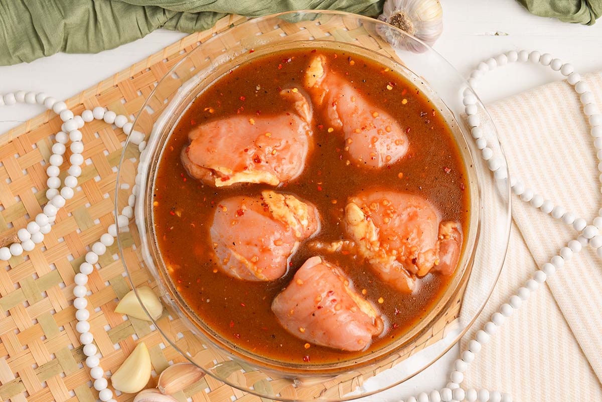 overhead shot of chicken thighs in marinade