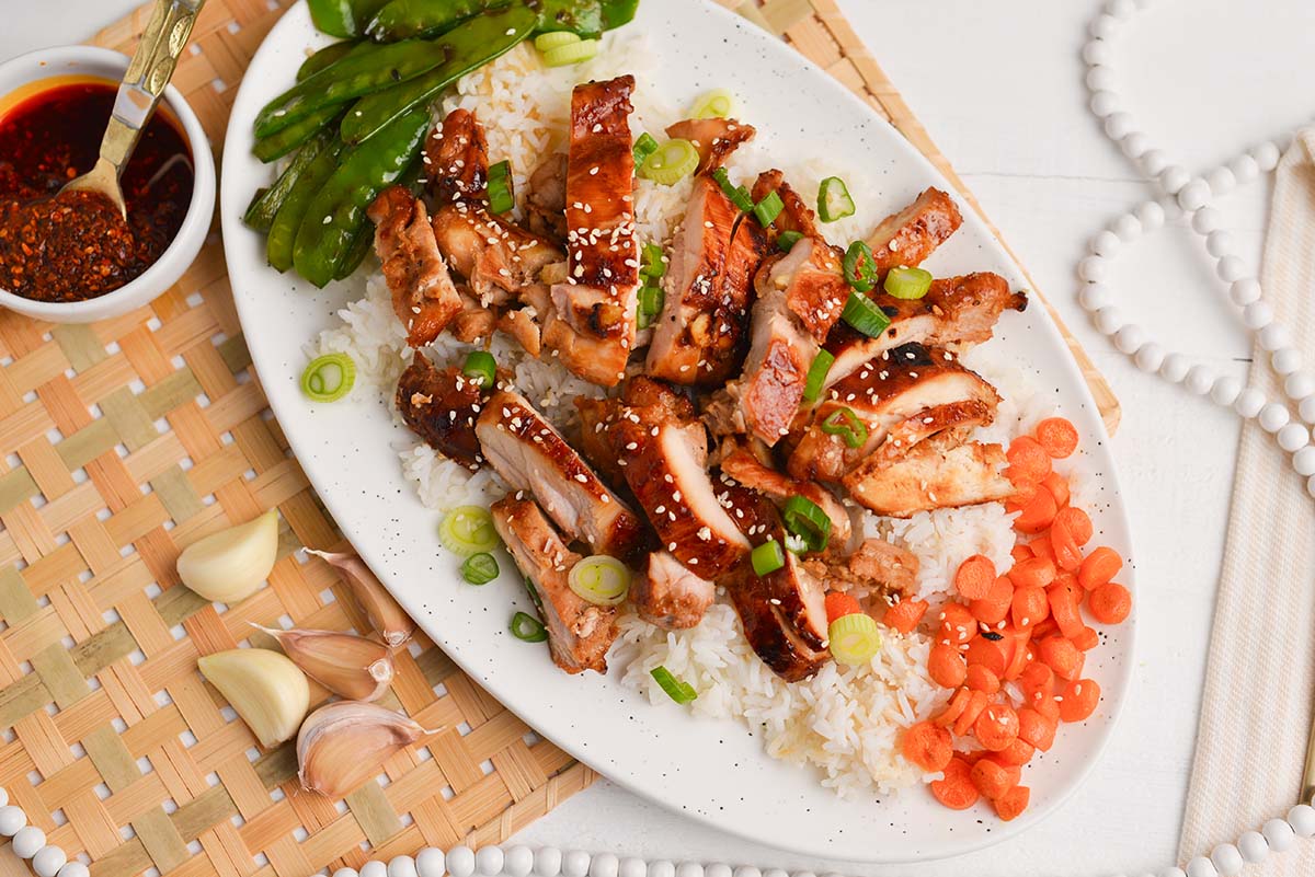 asian chicken marinated chicken on plate with rice and vegetables