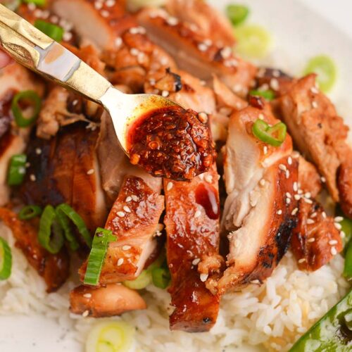 spoon adding sauce to chicken