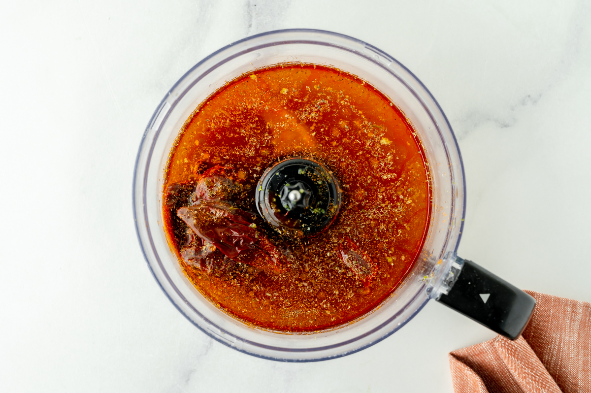 overhead shot of chipotle chicken marinade ingredients in food processor