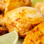 close up angled shot of chipotle chicken and lime