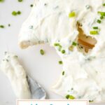 close up of bite taken out of bagel smothered with cream cheese with text overlay