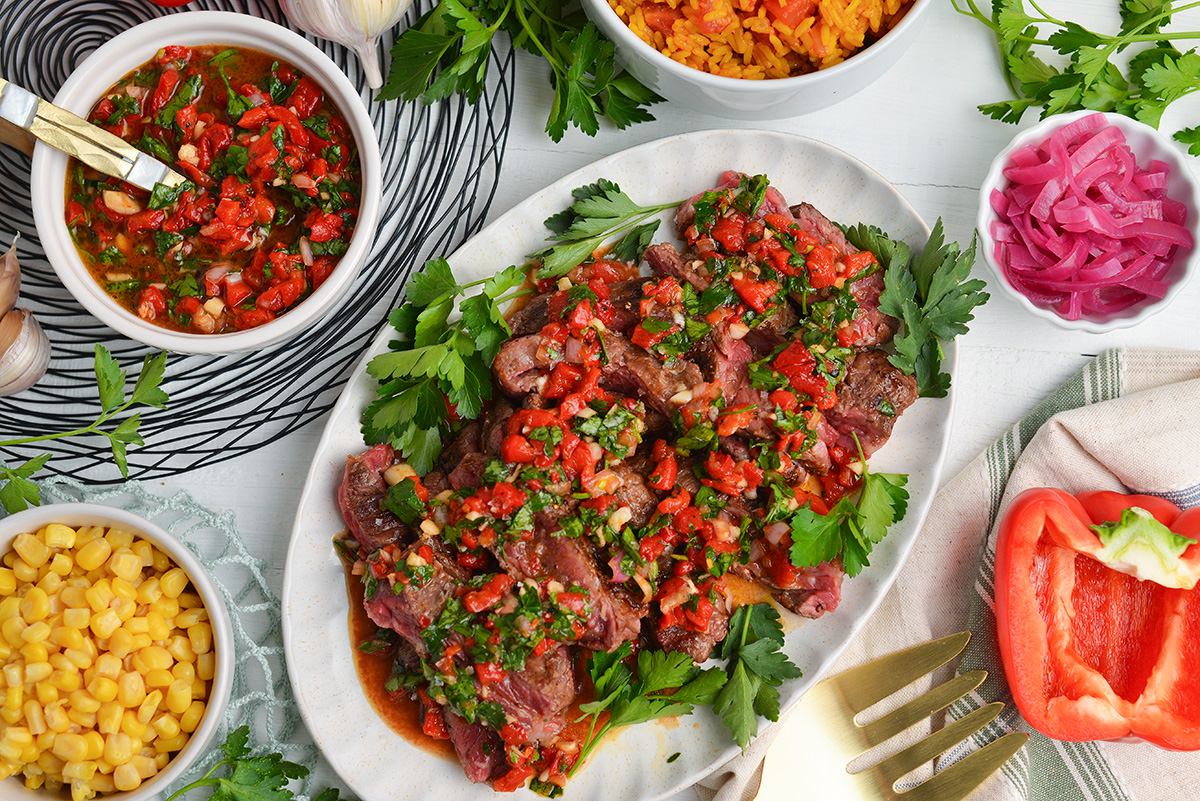 overhead shot of steak topped with red chimichurri sauce