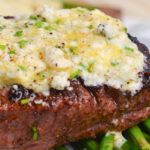 close up of blue cheese butter melting on steak