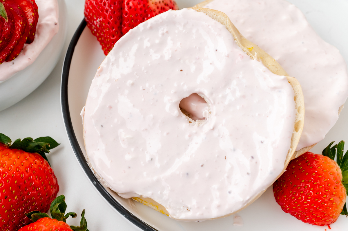 close up of fresh strawberry cream cheese on bagel