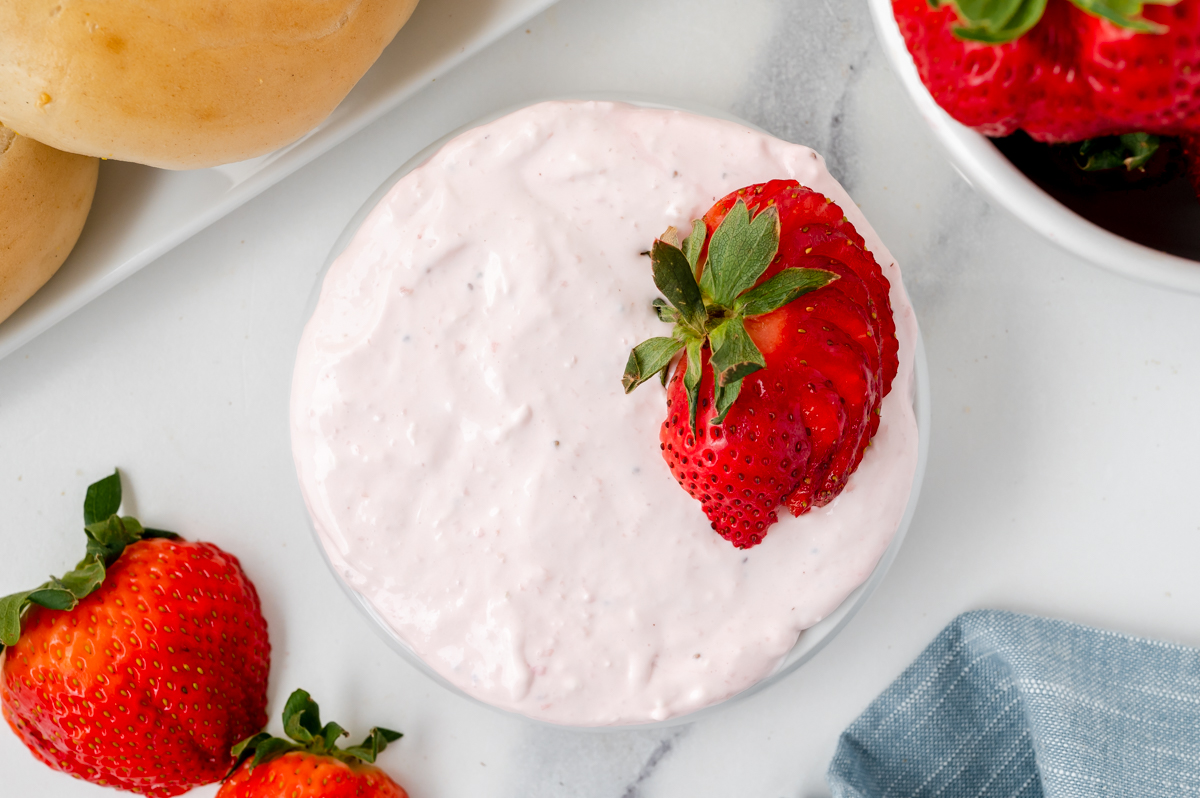 fresh strawberry cream cheese in white bowl with strawberries