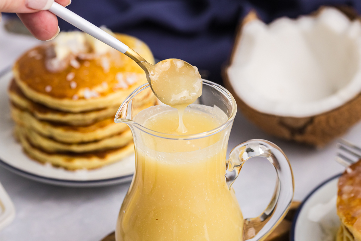 Sweet coconut sauce in a jar with shredded coconut
