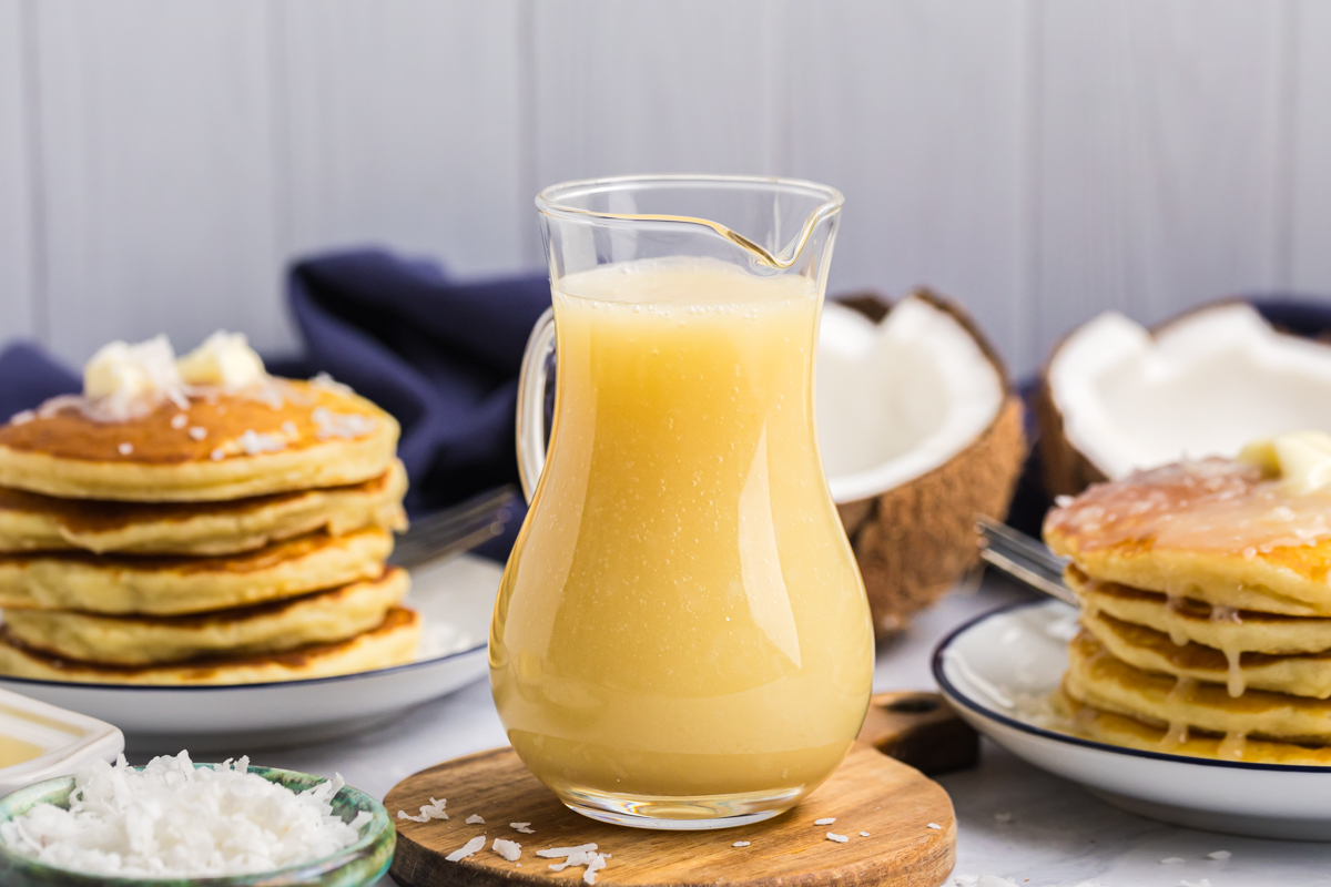 Warm sweet coconut sauce in a small clear pitcher